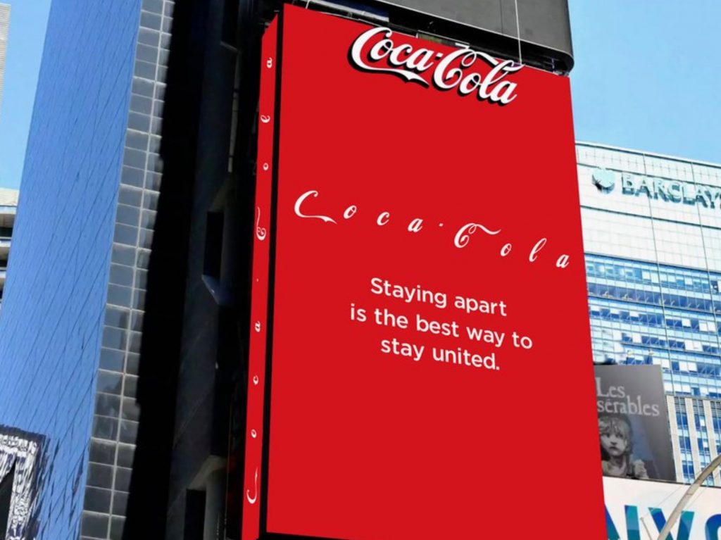 Coca Cola Social Distancing Logo Shown On An Ad In Times Square