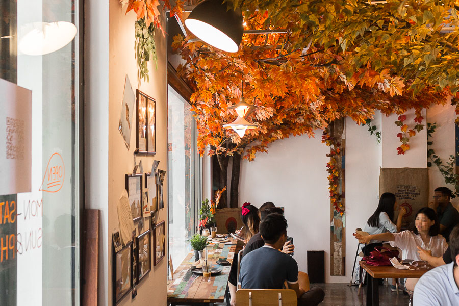 A corner of Kreams Cafe in Singapore at Maxwell Chambers. Autumn Leaves cover the ceiling of the cafe