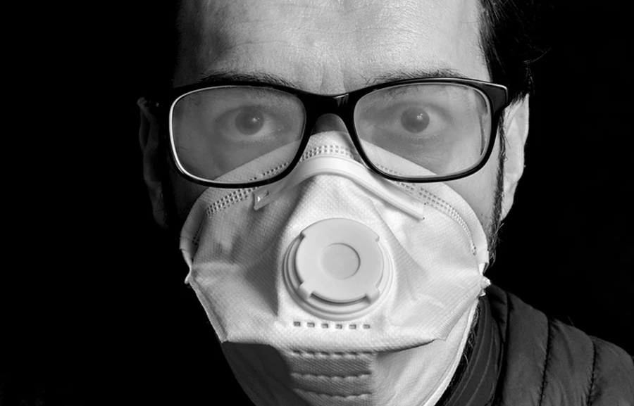 A man wearing face mask with fogging glasses