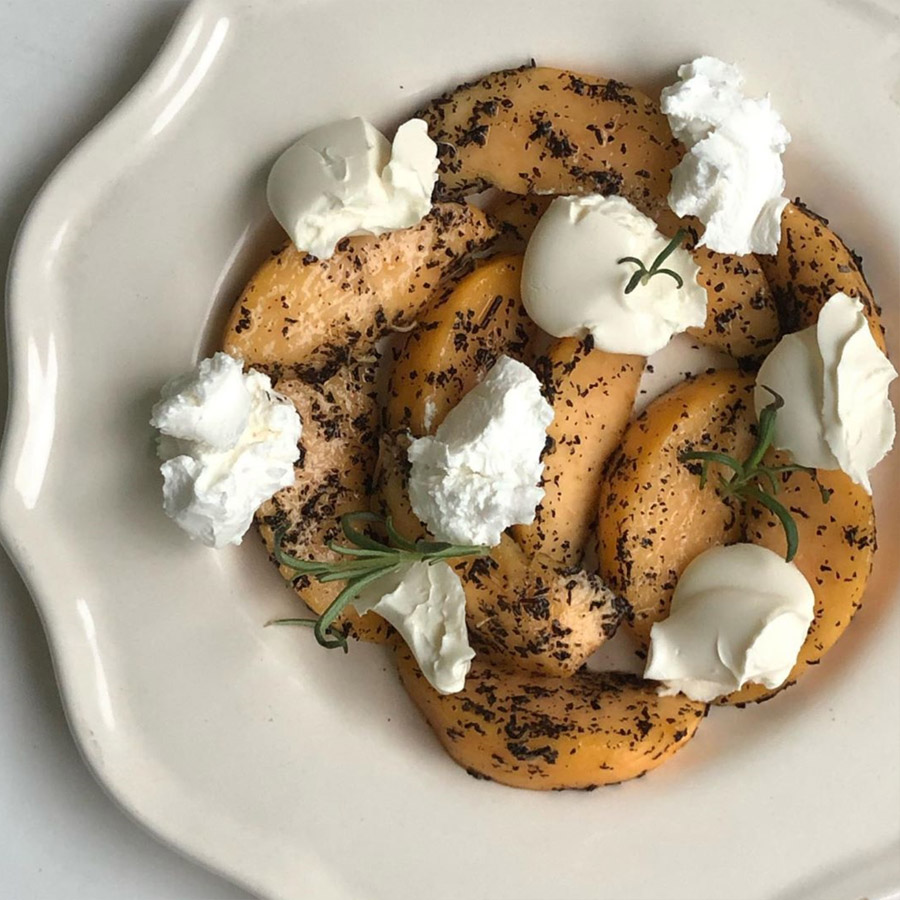 chunks of ricotta cheese on top of earl grey marinated peaches