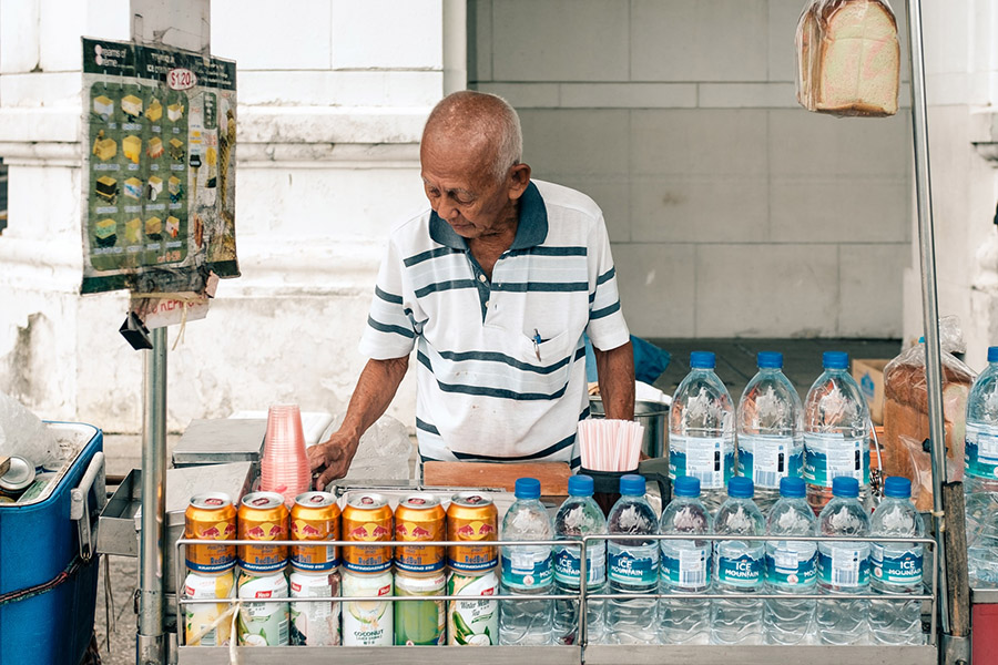 An elderly manning his roadside ice cream stall