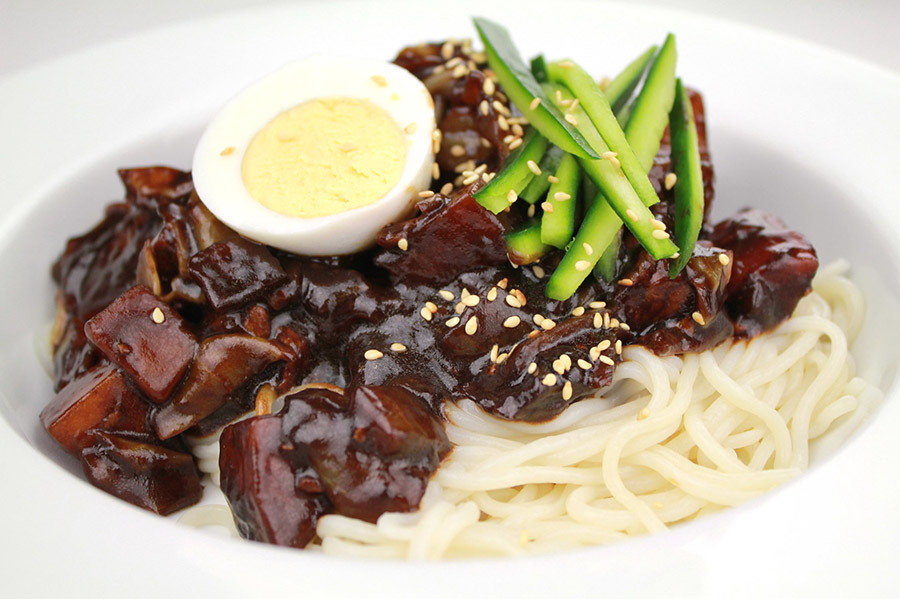 A Bowl of Jjajangmyeon with cucumber and egg toppings
