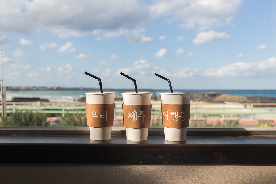 A photo of 3 drinks with a backdrop of Sehwa Beach in Jeju