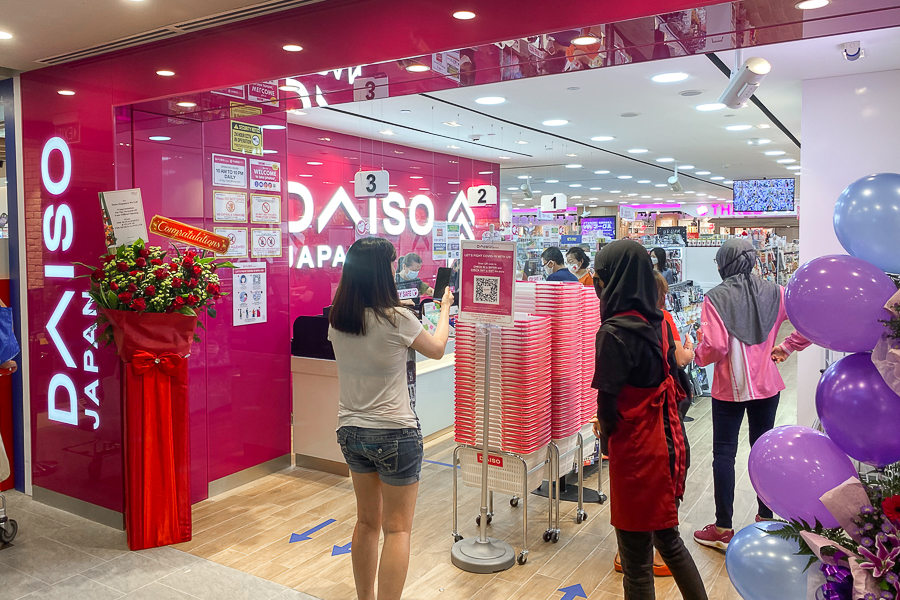 Someone doing SafeEntry at Daiso Canberra Plaza