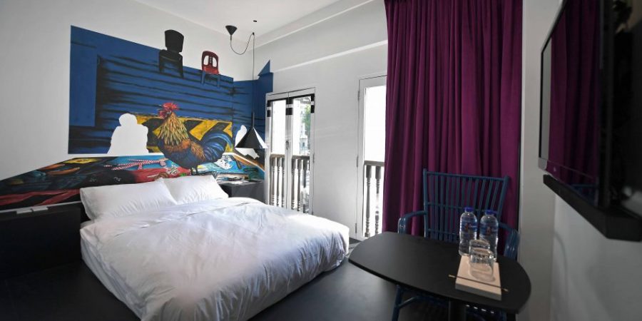 A Superior Room at XY Hotel Bugis with a hand painted wall by local artist