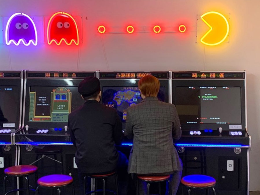Two Korean Boys Playing Old School Arcade Games