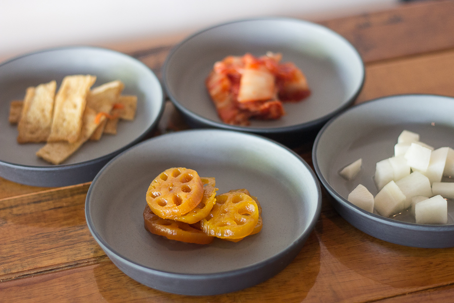 Side Dishes served at Ahtti, Lotus roots, fishcakes, kimchi and pickled radish
