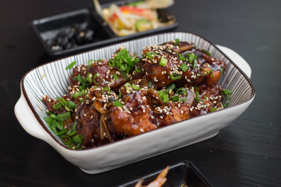 Soy Garlic Fried Korean Chicken topped with green onions and garlic slices