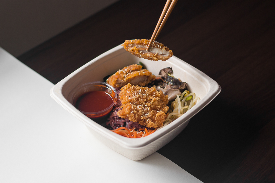 A box of delivered Spicy Chicken Katsu Bibimbap in a takeaway box from My Korean Mom's Kimchi in Singapore