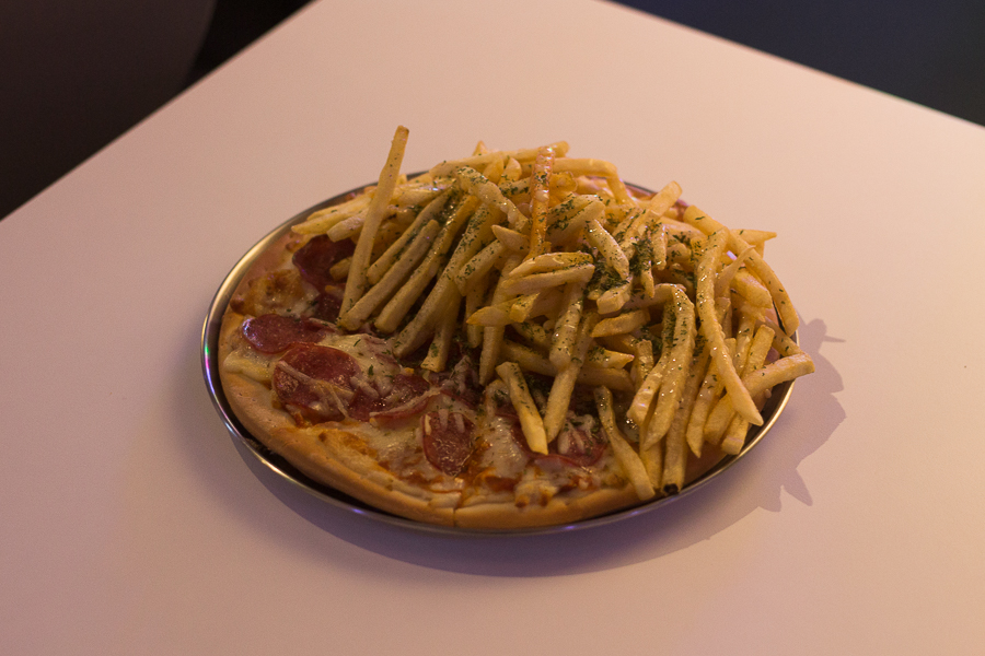 Pizza with half pepperoni topping and half fries topping