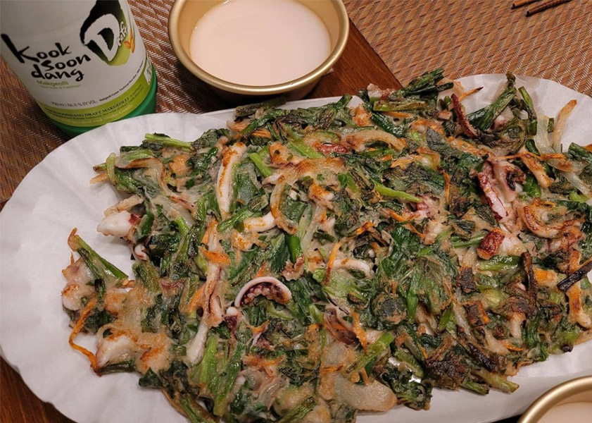 Green scallion pancakes from Korea with a cup of makgeolli