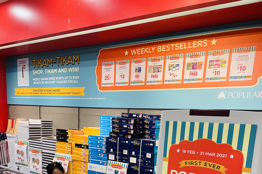 A banner in the IMM POPULAR outlet that showcases the Shop, Tikam and Win promotion