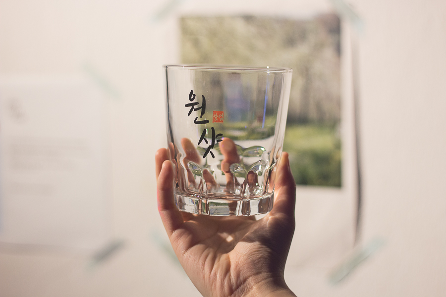 A huge soju glass that fits exactly one bottle of soju with the korean words printed on it saying One Shot