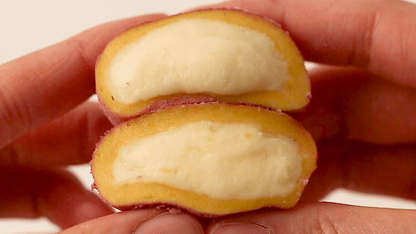 A GIF of someone squeezing sweet potato tteok