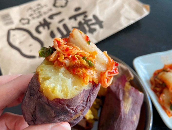 A slice of kimchi on top of baked sweet potato