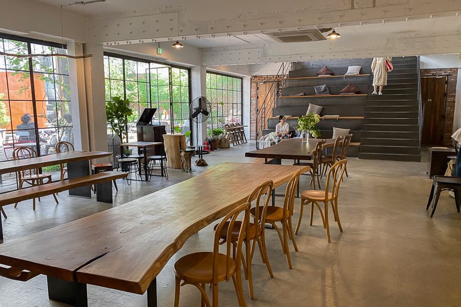 Grandpa Factory Interior with a huge wooden table and seats on stairs