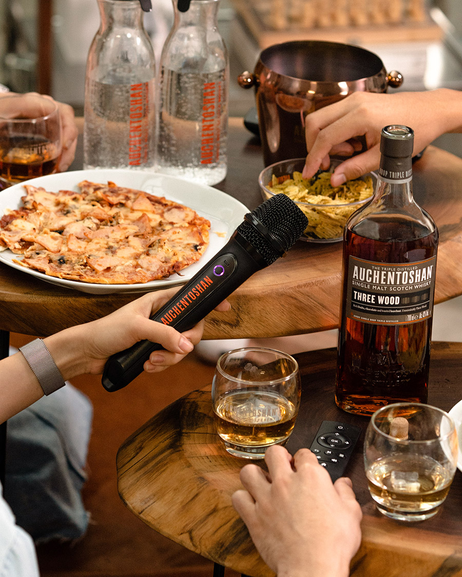 Someone holding a Microphone at home with Auchentoshan Label