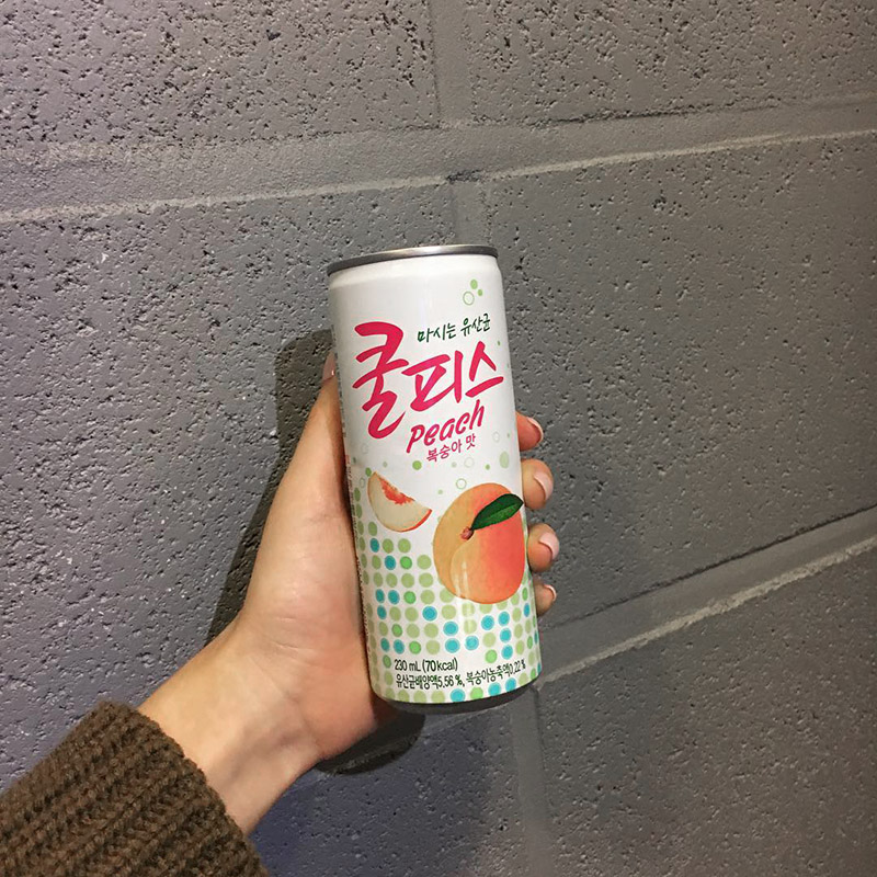 Someone holding a can of Coolpis Peach from Korea
