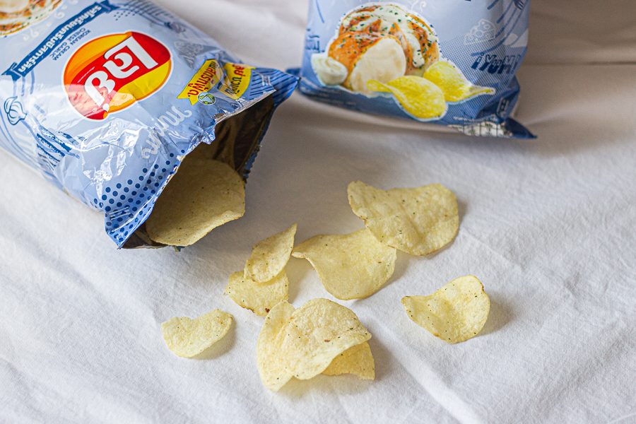Packaging and Chips coming out of a Korean Cream Cheese Garlic Potato Chip Bag from Lays Thailand