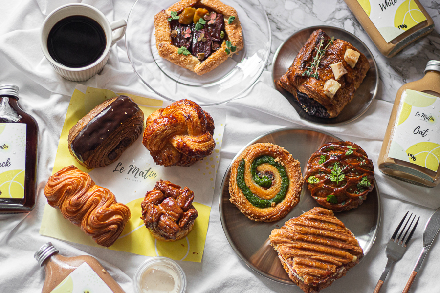 Flatlay of Le Matin Patisserie Pastries and Bottled Brews
