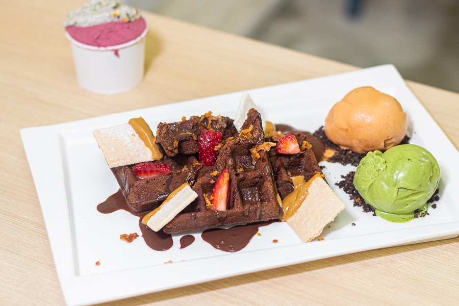 Brownie waffles with strawberries, a scoop of matcha gelato and a scoop of thai milk tea gelato