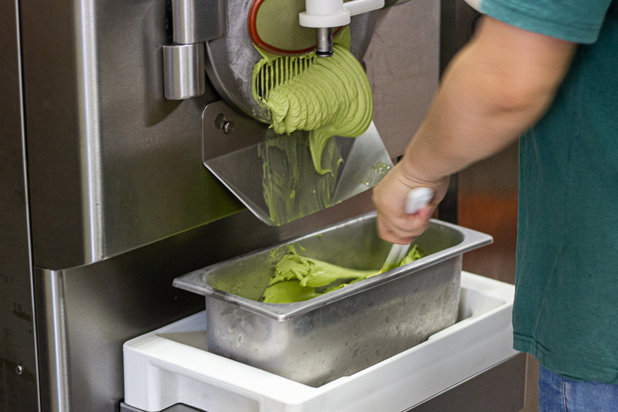 matcha gelato coming out of a churner