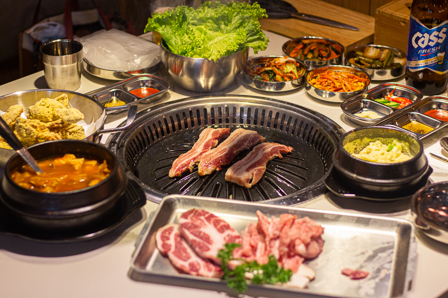 Holland Village KBBQ Restaurant - Table filled with assorted side dishes, Korean fried chicken and BBQ Meat