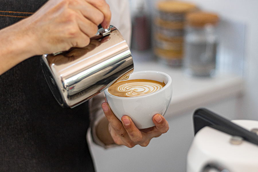 Barista making Latte Art on a cup of coffee