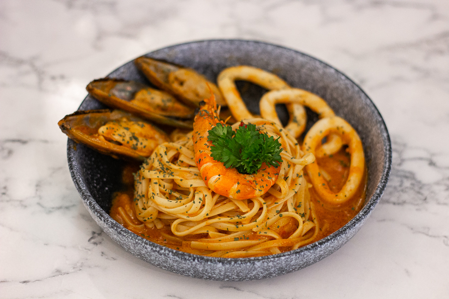 A plate of Tom Yum Seafood Pasta