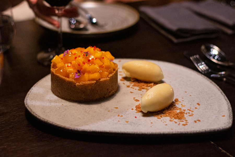 Baked Vanilla Cheesecake topped with mango and a side of pineapple sorbet