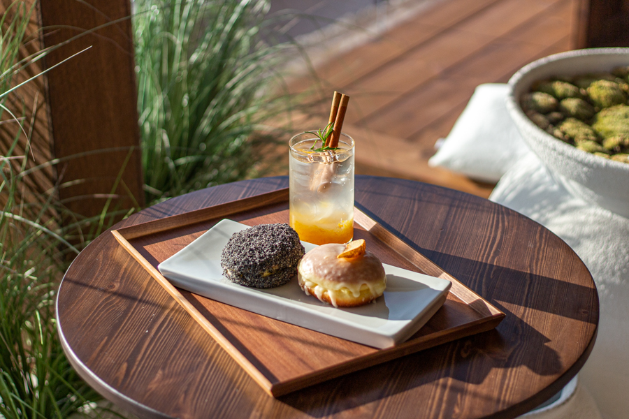 a black sesame donut with a potato donut and a yuja ade