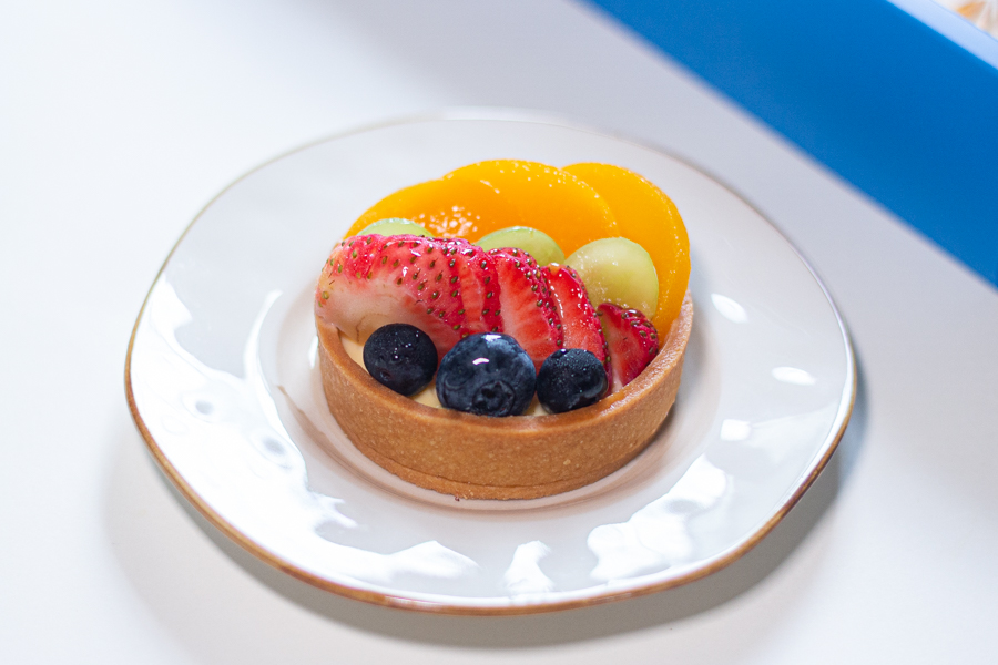 Mixed Fruits Tart with fruits such as Strawberries, Peach, Green Grapes and Blueberries