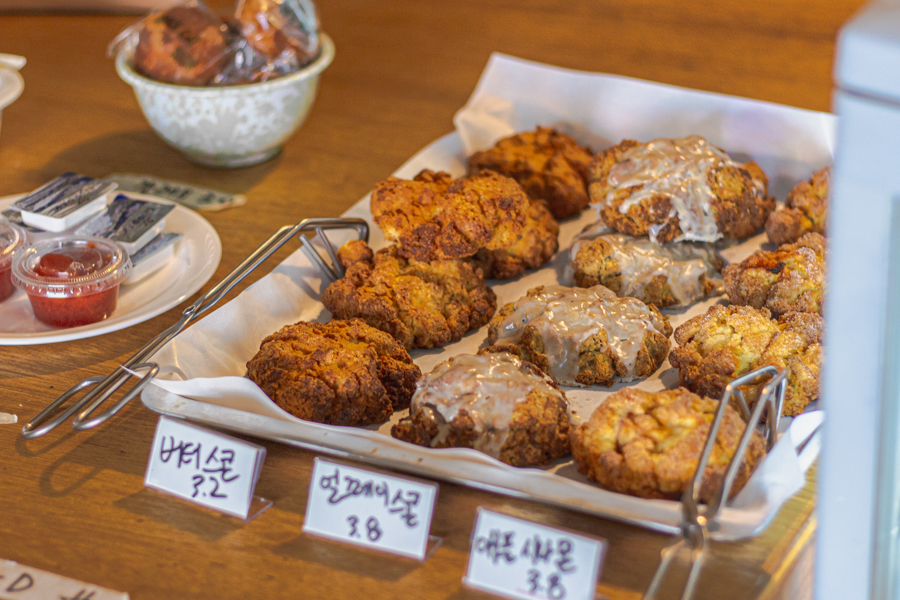 Scones on Display At Cafe Sick Cat Sign