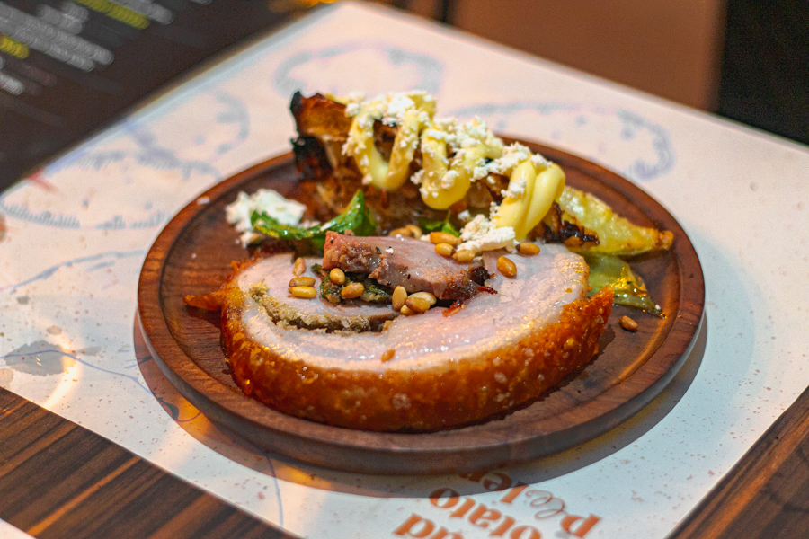 Italian Porchetta with wood-fired cabbage, feta cheese and toasted pine nuts