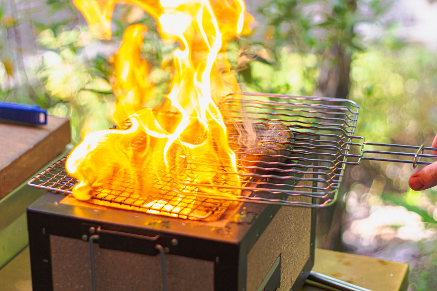 Grilling of Housemade Sausage over Charcoal Fire