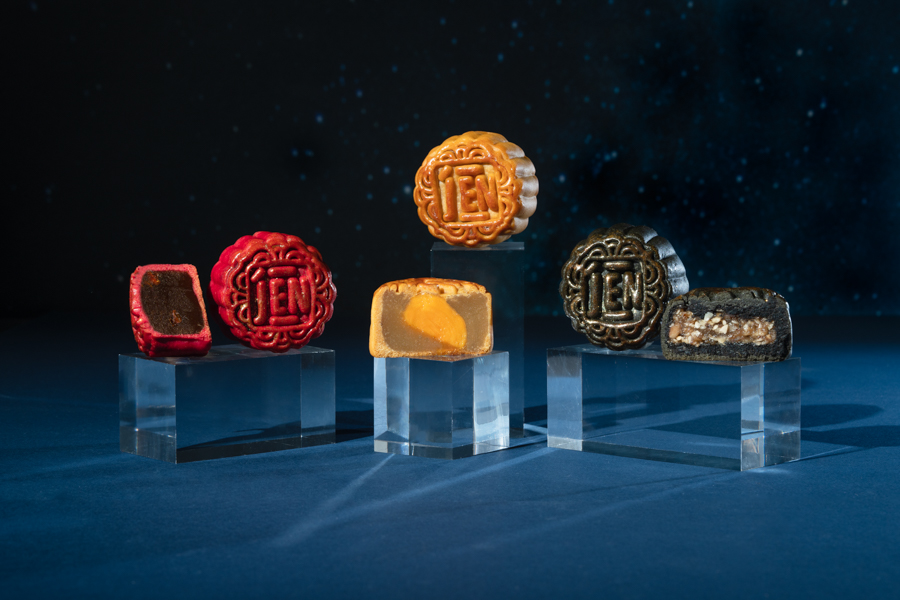 Three mooncakes in different flavours including white lotus and salted egg yolk, mixed nuts and truffle, red date and goji berry
