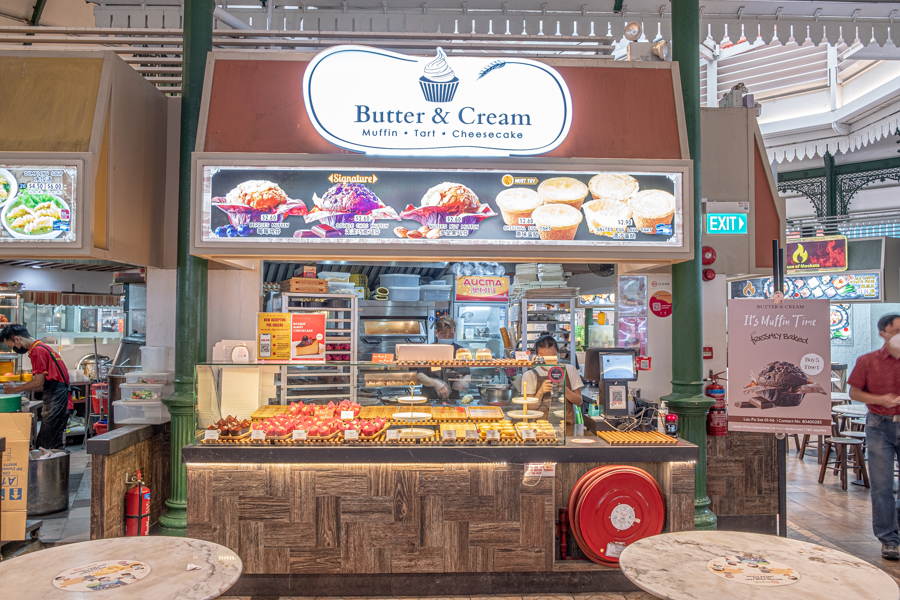 Storefront of Butter & Cream Bakery at Lau Pa Sat hawker center, selling freshly baked muffins and egg tarts