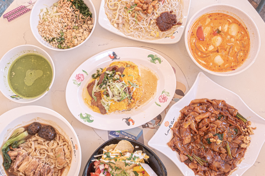 An assortment of Singaporean hawker foods like hokkien mee, thunder tea rice, hor fun and more