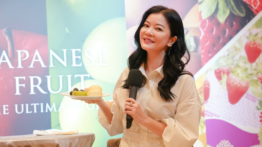 Singaporean actress, director and producer Michelle Chong holding a plate of fresh Japanese fruit