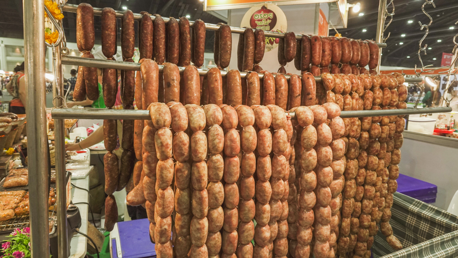 Thai-styled E-Sarn sausages being hung up to dry before cooking