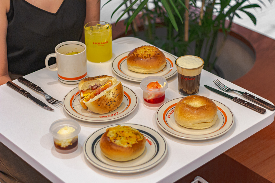 A full table of Korean style bagels, bagel sandwiches and drinks at B For Bagel 