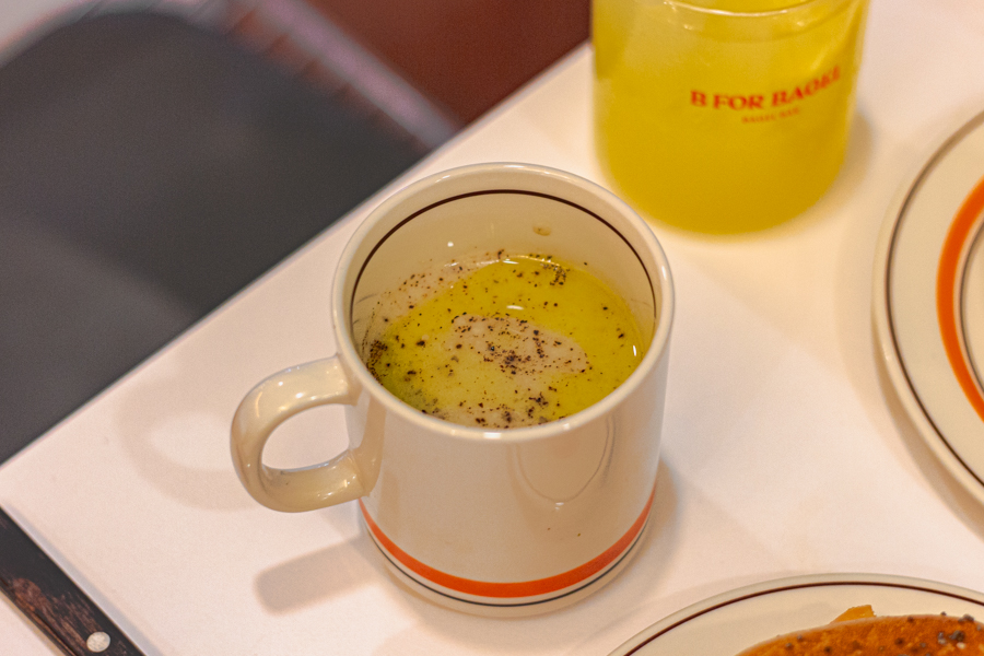 A mug with truffle artichoke soup by B For Bagel