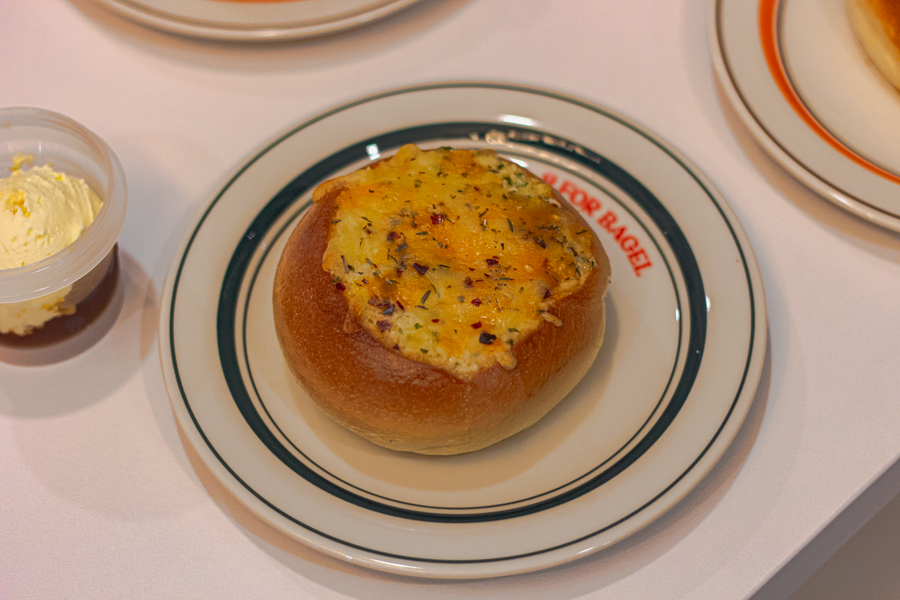 A plate holding a Korean style Garlicbutter Cheese bagel