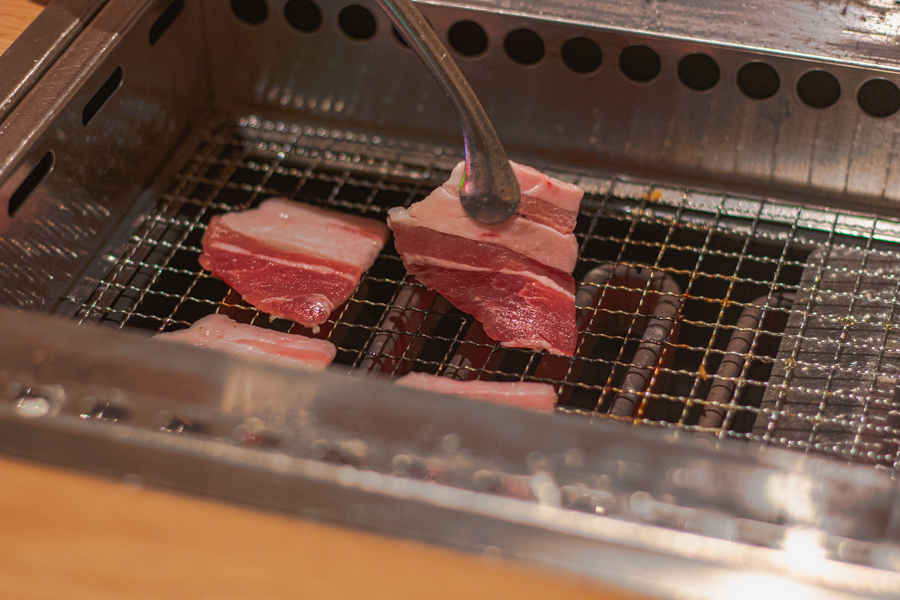 A slice of Japanese yakiniku pork belly on the grill