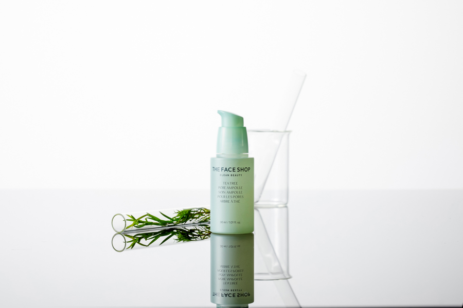 A bottle of Korean skincare, a tea tree ampoule by THEFACESHOP