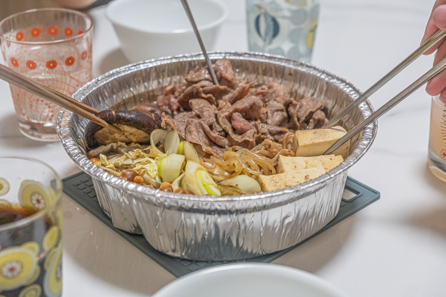 A group of people enjoying the wagyu Sukiyaki 