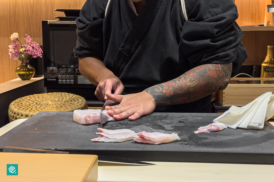 Chef Masa from Sushi Masa slicing fresh sashimi 