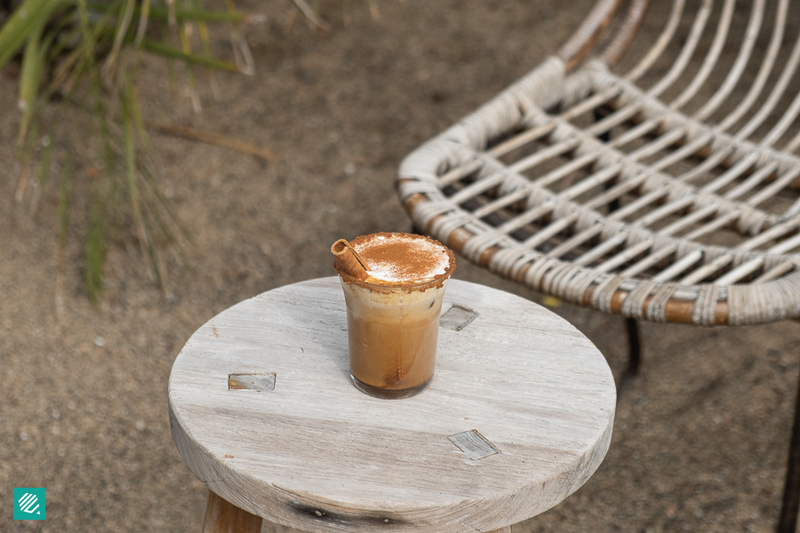 A cup of Cinnamon Cream Latte on top of a white table