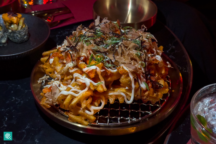 A Plate of Kimchi Bacon Fries topped with bonito flakes