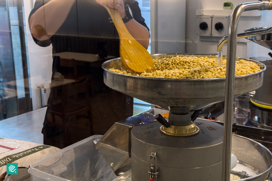 Someone making Soontofu using soaked soybeans in Singapore